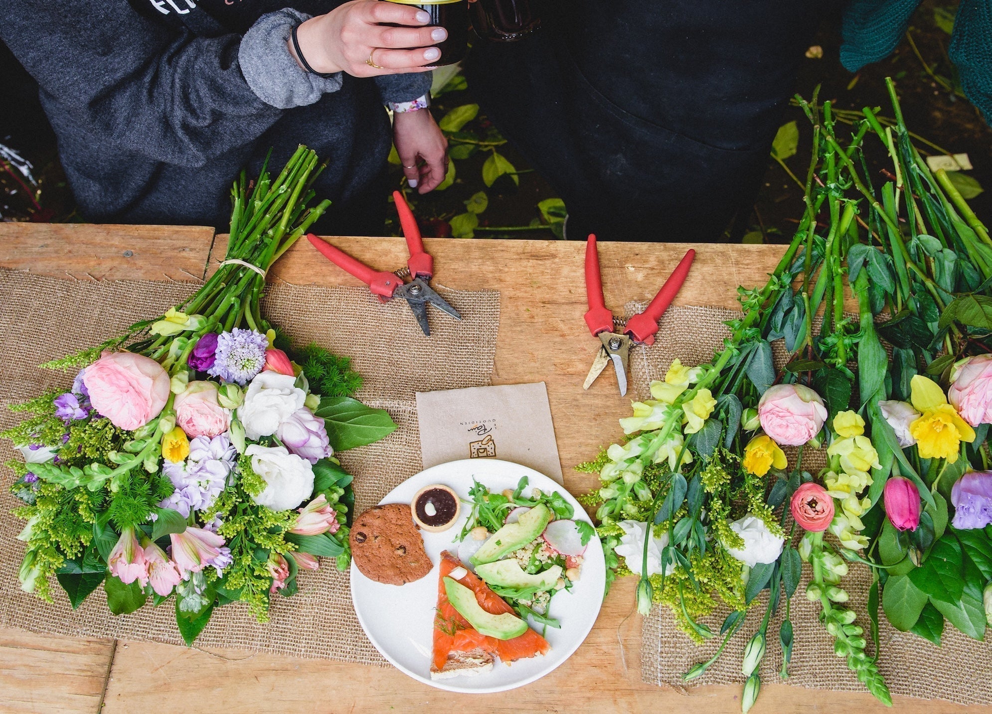 Flowers being arranged into a bouquet at Flower for Dreams’ open studio.