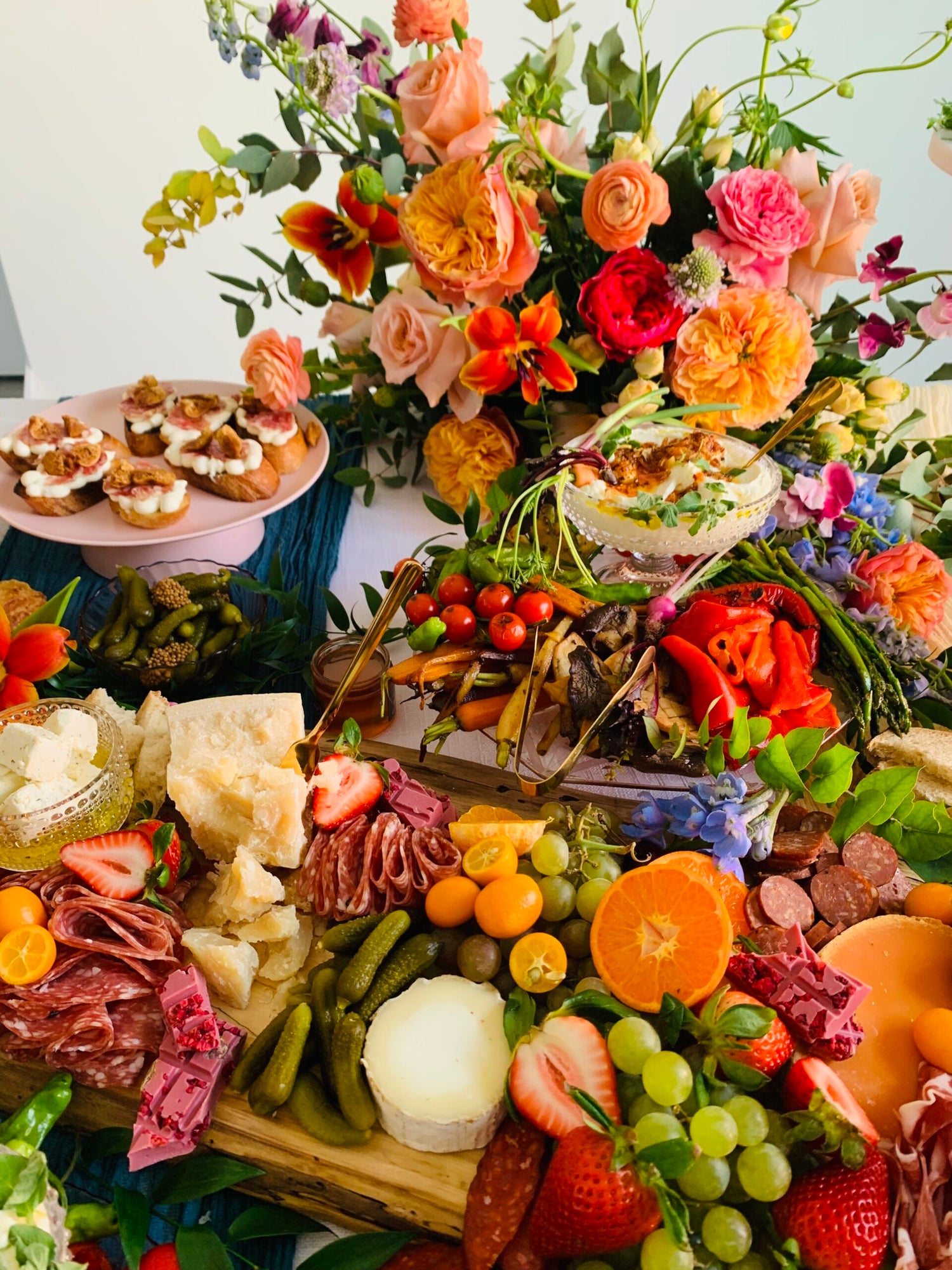 Behind the scenes of a wedding shoot showcasing beautiful flower arrangements being set up to create a stunning backdrop for the event.