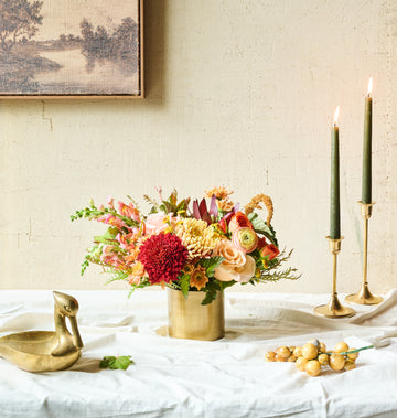 Autumn Bouquet – Warm fall bouquet with peach, rust, and amber blooms wrapped in burlap for a cozy seasonal look.