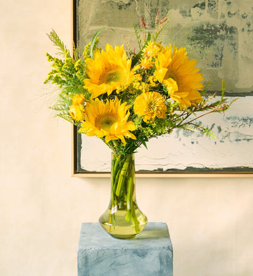Amber: Bouquet of dahlias, marigolds, and golden foliage for a warm autumn look.