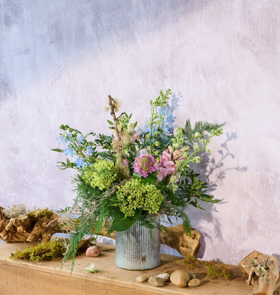 Meadow bouquet in a tin vase with mixed wildflowers