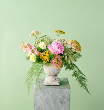 Romantic floral arrangement featuring pastel-toned seasonal flowers with airy textures and garden-inspired styling.