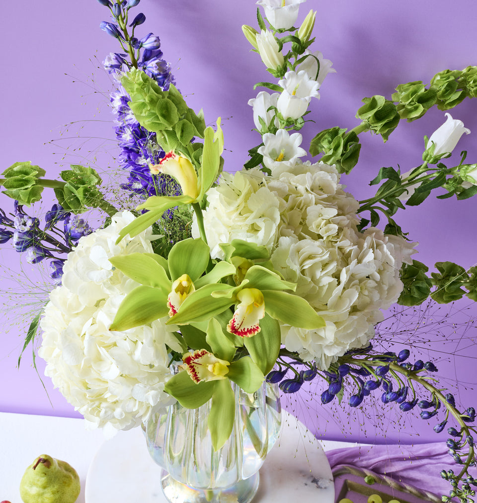 Botanica bouquet with rich greenery and seasonal flowers