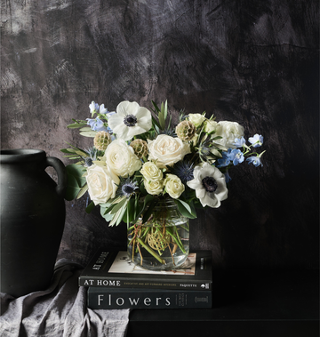 Winter Bouquet by Flowers for Dreams with white roses blue thistles and anemones
