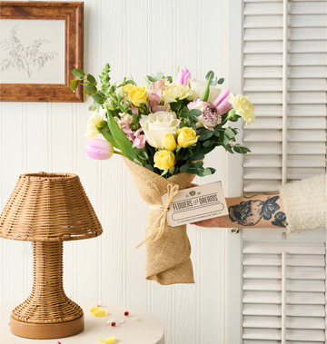 Fresh pink tulips arranged in a clear glass vase, featuring soft seasonal blooms with bright green stems, handcrafted by Flowers for Dreams.