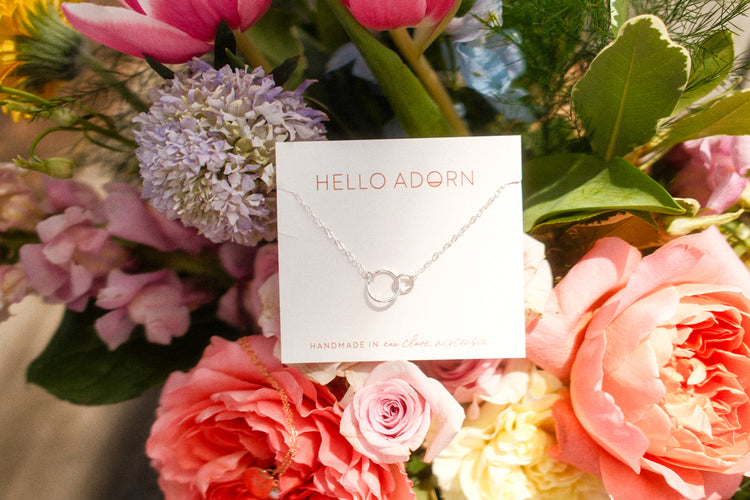 Hello Adorn necklace in silver, close-up of pendant detail