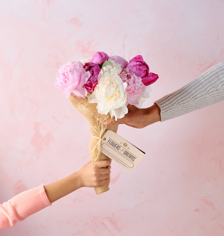 Peony bouquet in a tote bag, lush pink blooms