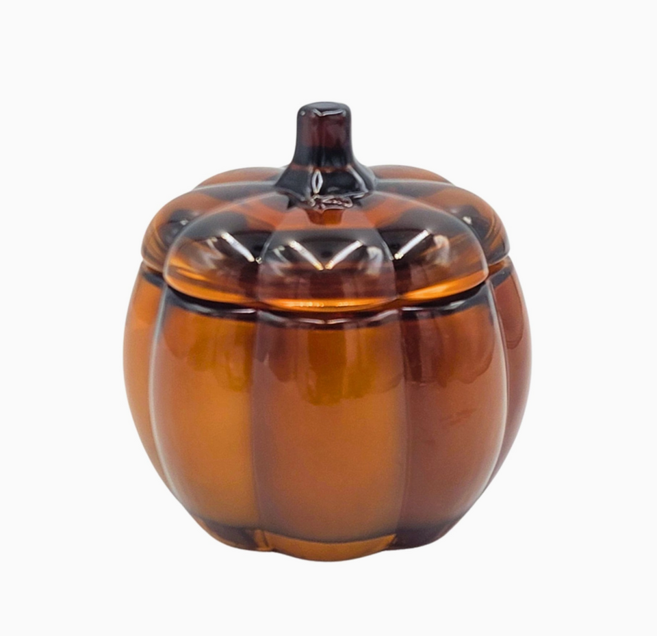 Amber glass pumpkin-shaped candle vessel with lid on white background