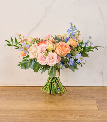 Soft blush and ivory floral arrangements for a romantic wedding.